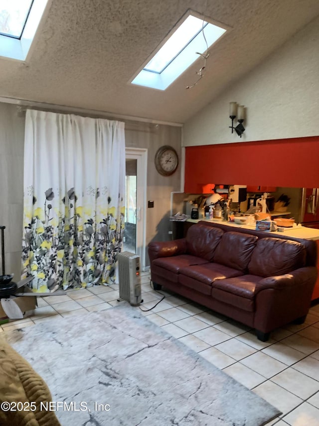 tiled living room featuring vaulted ceiling with skylight and a textured ceiling