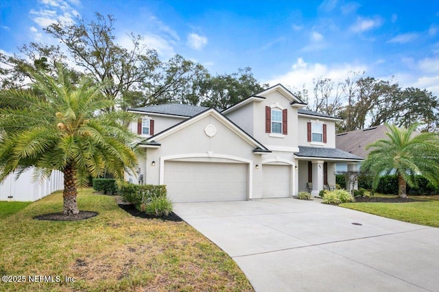 view of front of house with a front yard and a garage