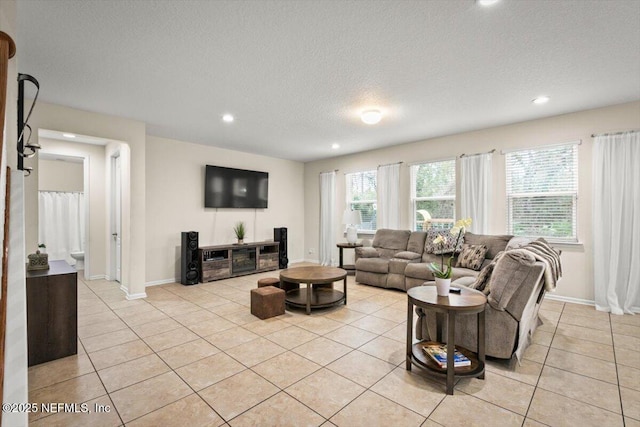 living room with light tile patterned floors and a textured ceiling