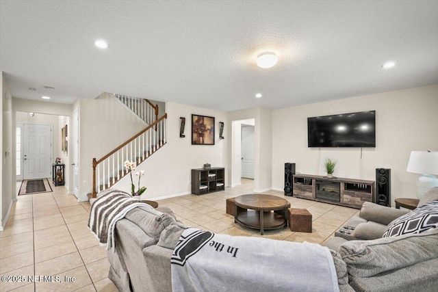 living room featuring light tile patterned floors and a textured ceiling