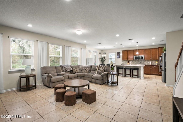 tiled living room featuring a textured ceiling