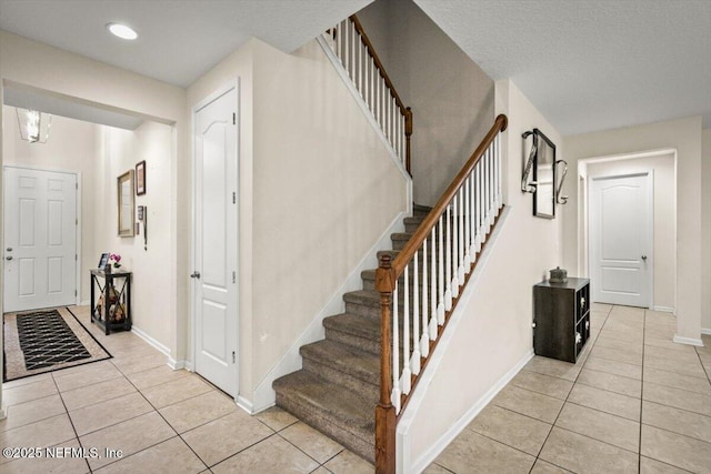 staircase featuring tile patterned flooring