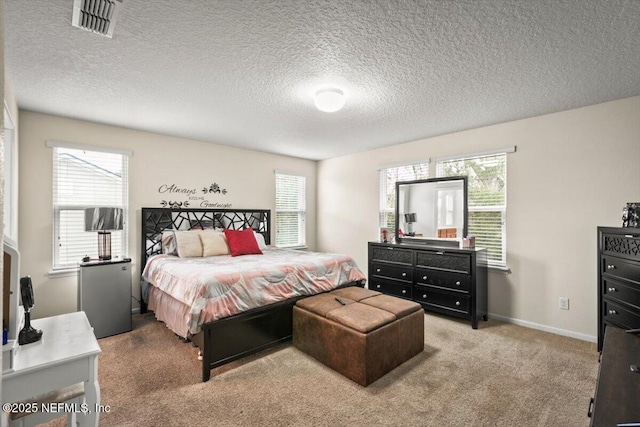 carpeted bedroom featuring a textured ceiling