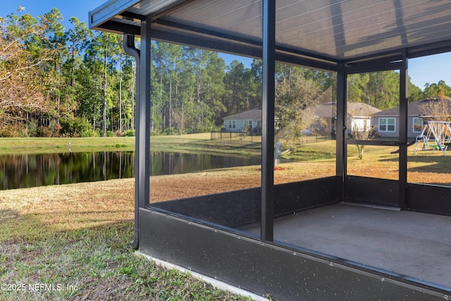 unfurnished sunroom featuring a water view