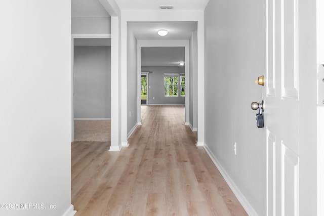 corridor with light wood-type flooring