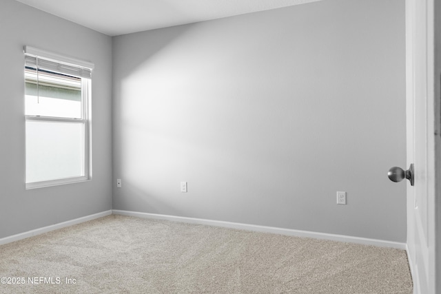 carpeted spare room with a wealth of natural light