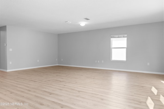 spare room featuring light wood-type flooring