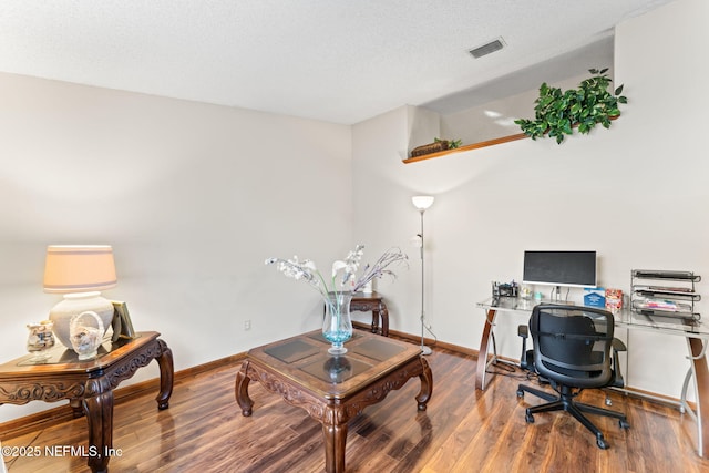 office featuring a textured ceiling and hardwood / wood-style floors