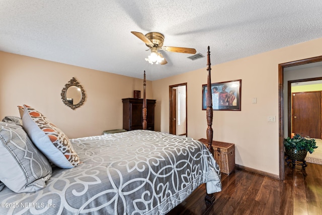 bedroom featuring a textured ceiling, ceiling fan, and dark hardwood / wood-style floors