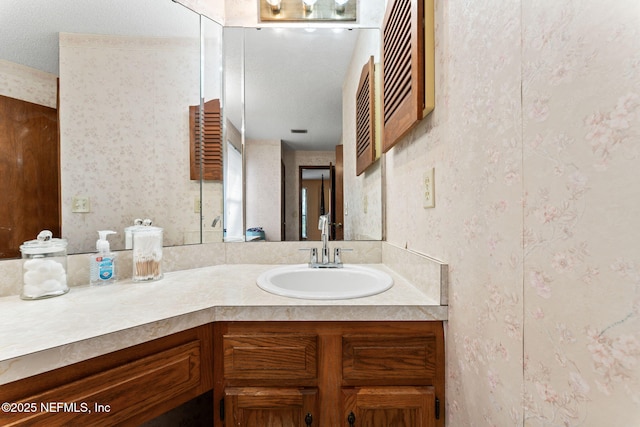 bathroom featuring a textured ceiling and vanity