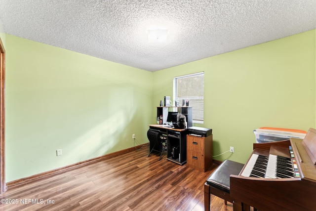 office space featuring a textured ceiling and dark hardwood / wood-style flooring