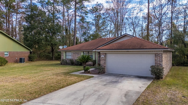 single story home featuring a front yard, a garage, and central AC unit