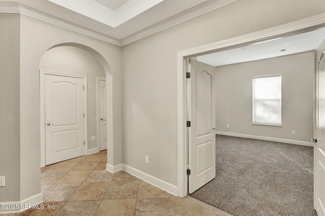 corridor with light carpet and crown molding