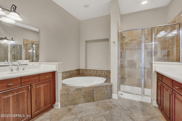 bathroom featuring vanity and independent shower and bath