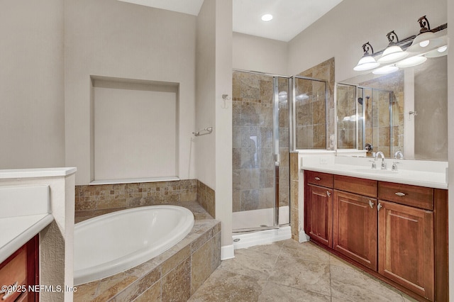 bathroom featuring shower with separate bathtub and vanity