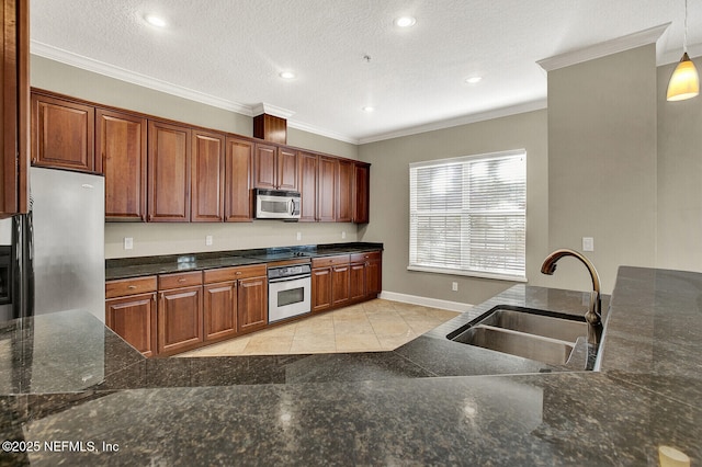 kitchen featuring appliances with stainless steel finishes, a textured ceiling, crown molding, sink, and decorative light fixtures