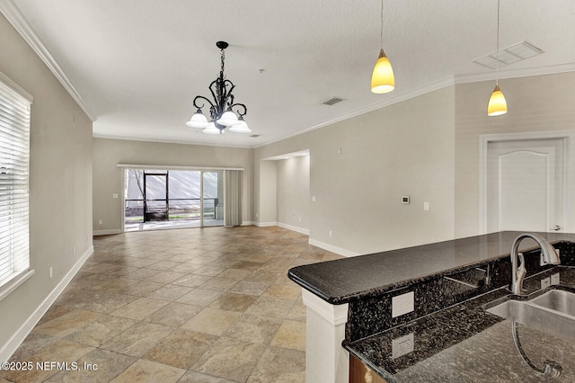 kitchen with plenty of natural light, sink, hanging light fixtures, and a chandelier