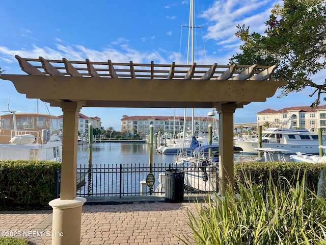 view of dock with a pergola and a water view