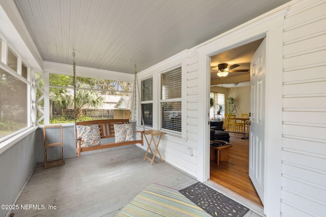 sunroom with a healthy amount of sunlight and ceiling fan