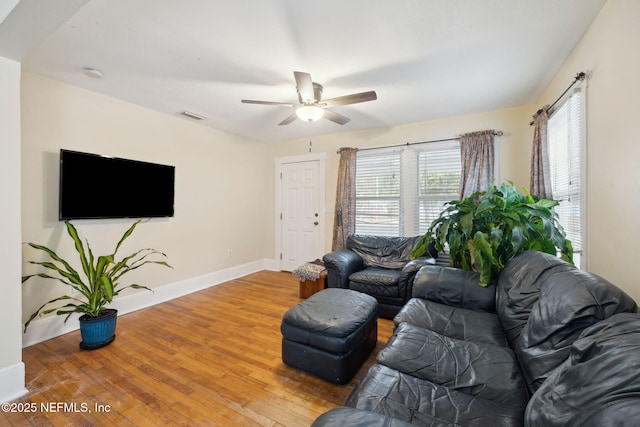 living room featuring ceiling fan and hardwood / wood-style flooring