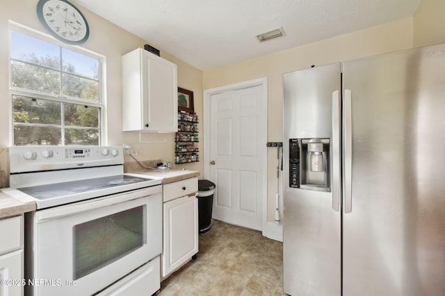 kitchen with white cabinetry, white range with electric cooktop, tile countertops, and stainless steel fridge with ice dispenser