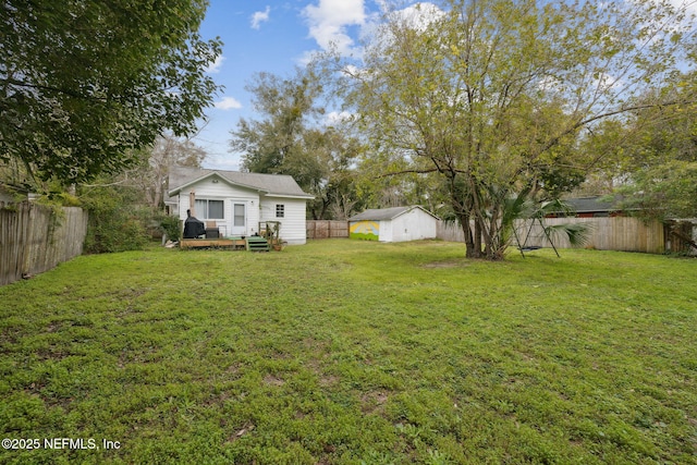 view of yard featuring a storage shed and a wooden deck