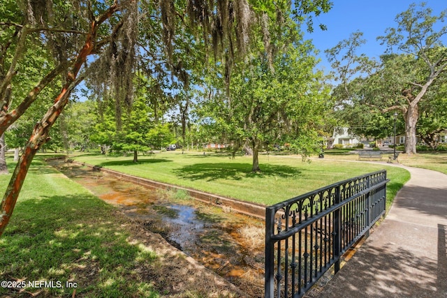 view of property's community featuring a lawn