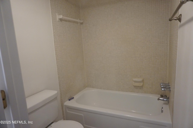 bathroom featuring shower / tub combination and toilet