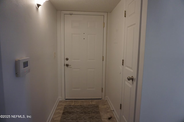 doorway with a textured ceiling