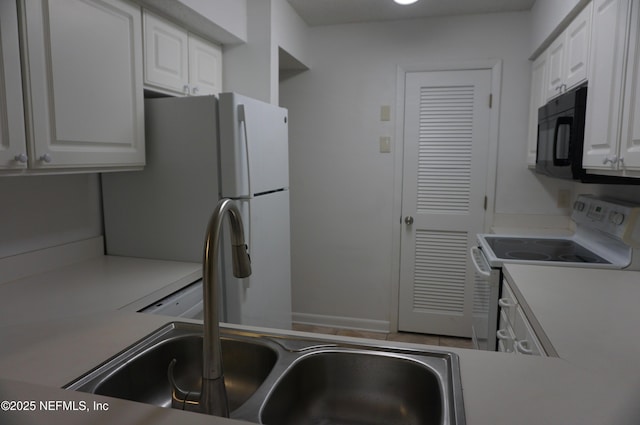 kitchen featuring electric stove, white cabinetry, and sink