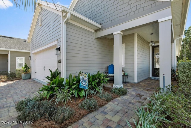 property entrance with a porch and a garage