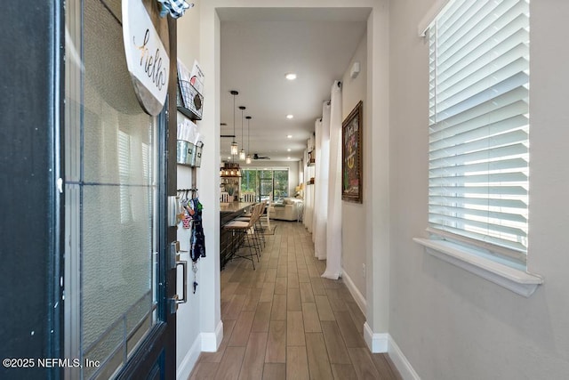 hall with recessed lighting, baseboards, and wood finished floors