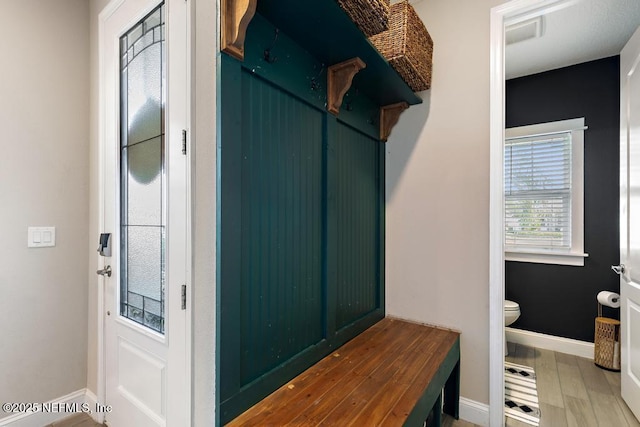 mudroom with baseboards and wood finished floors