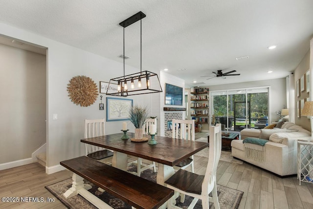 dining room with light wood finished floors, baseboards, a ceiling fan, and recessed lighting