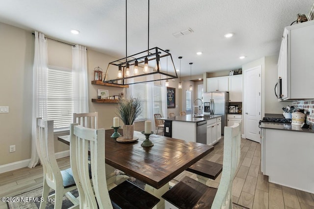 dining space featuring a textured ceiling and sink