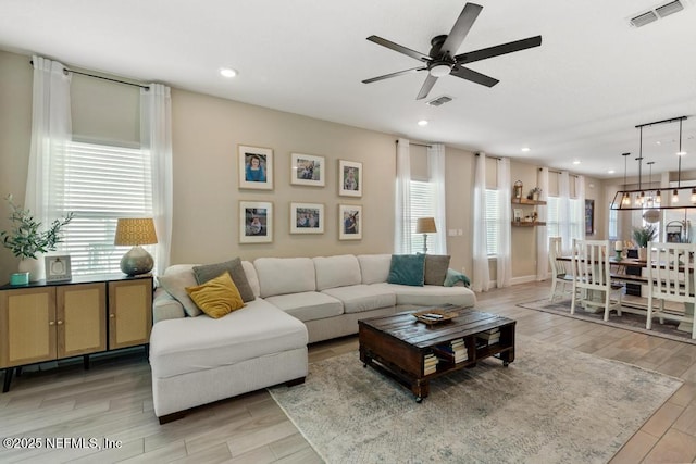 living room with ceiling fan and a wealth of natural light