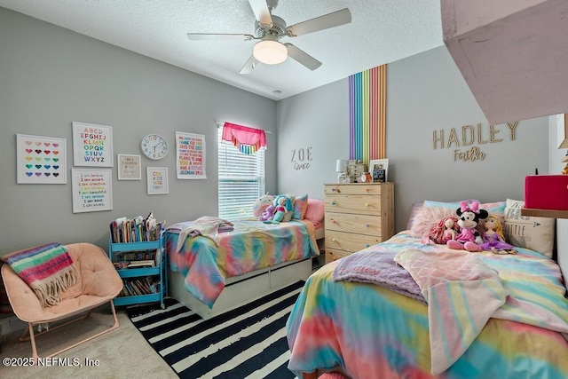 bedroom featuring ceiling fan, carpet floors, and a textured ceiling