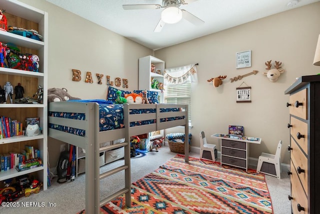 carpeted bedroom featuring ceiling fan and baseboards