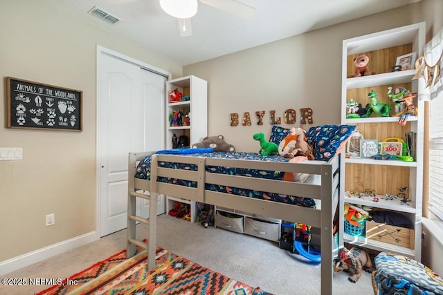 carpeted bedroom with a closet, visible vents, ceiling fan, and baseboards