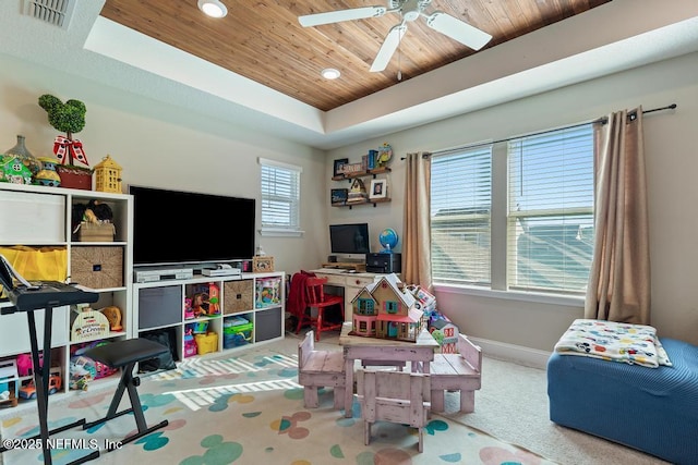 playroom featuring carpet floors, visible vents, wood ceiling, baseboards, and a tray ceiling