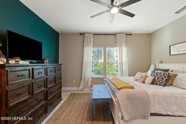 bedroom featuring light carpet, baseboards, visible vents, a ceiling fan, and a textured ceiling