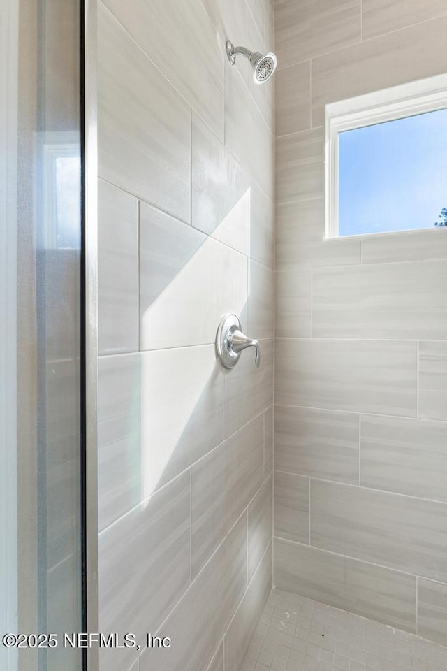 bathroom with tiled shower