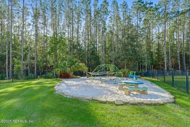 surrounding community featuring playground community, a yard, and fence