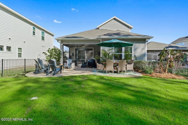 back of property featuring a patio area, fence, a sunroom, and a lawn