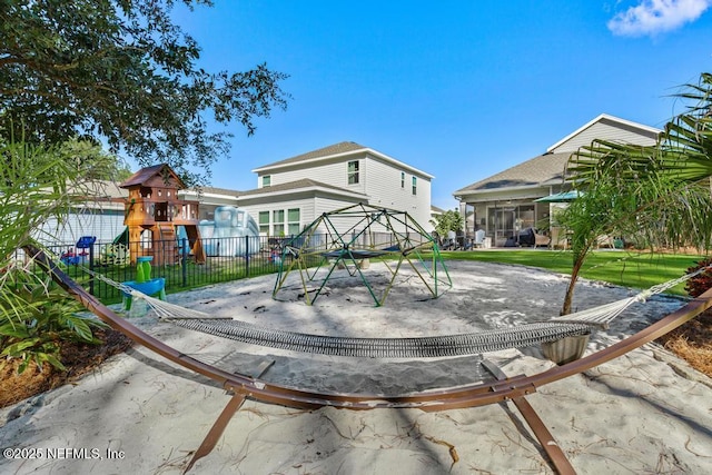 view of jungle gym featuring a lawn