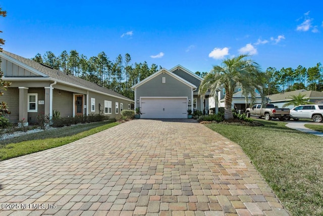 view of front facade with an attached garage, a front lawn, and decorative driveway