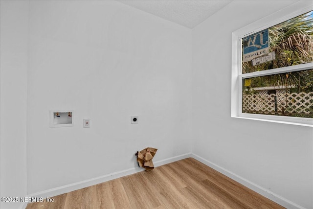 laundry room featuring hardwood / wood-style flooring, a textured ceiling, hookup for a washing machine, and hookup for an electric dryer