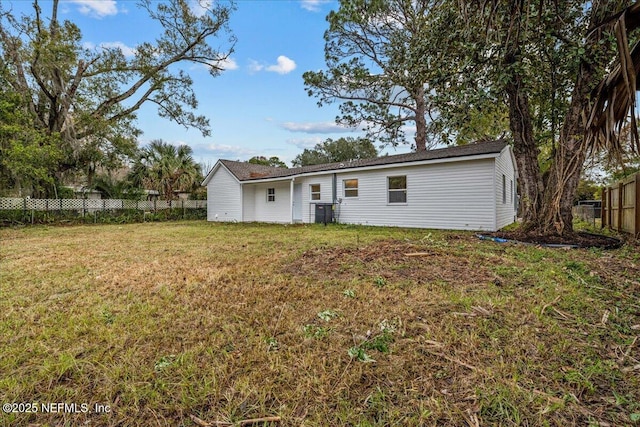 rear view of house with a yard