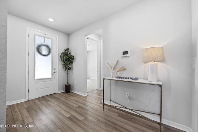 entryway with hardwood / wood-style floors