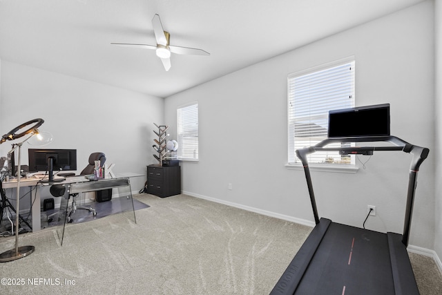 office area featuring light carpet and ceiling fan